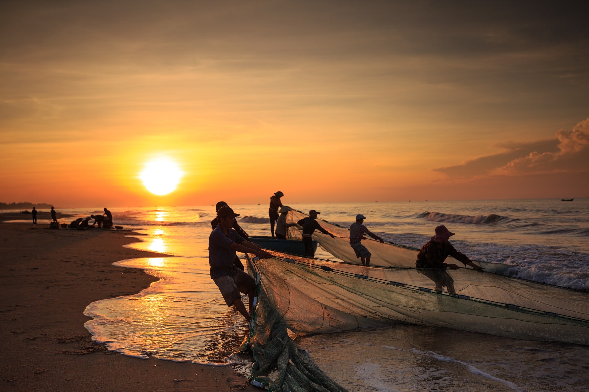 Photo of fishermen pulling together